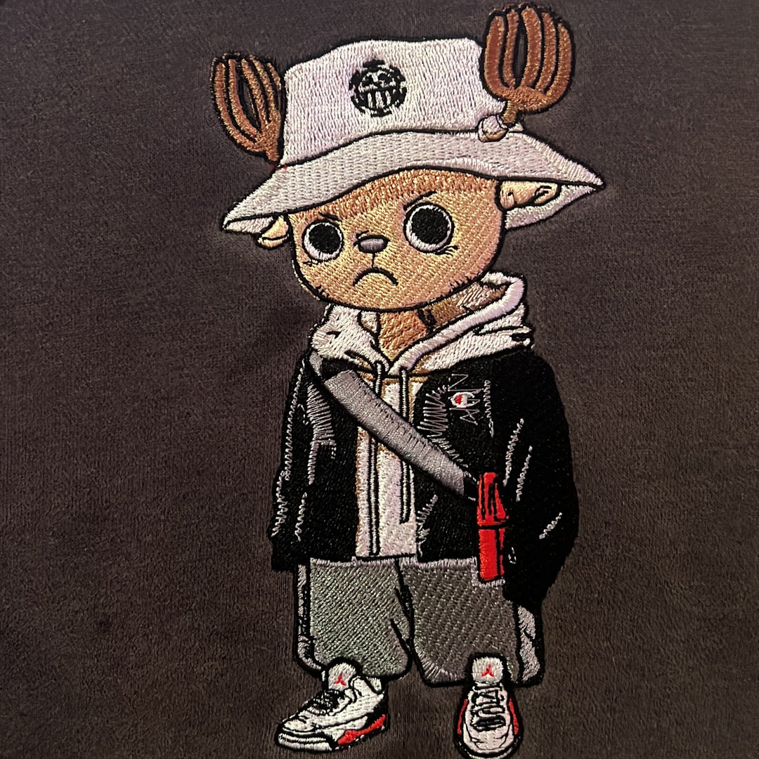 Hoodie brodé The Snowborn Reindeer Kaito Global — gros plan du motif sur textile.