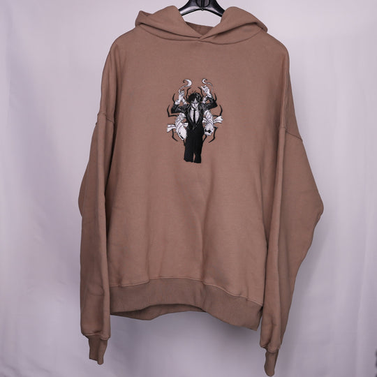 Hoodie brodé The False Prophet Kaito Global — gros plan du motif sur textile.